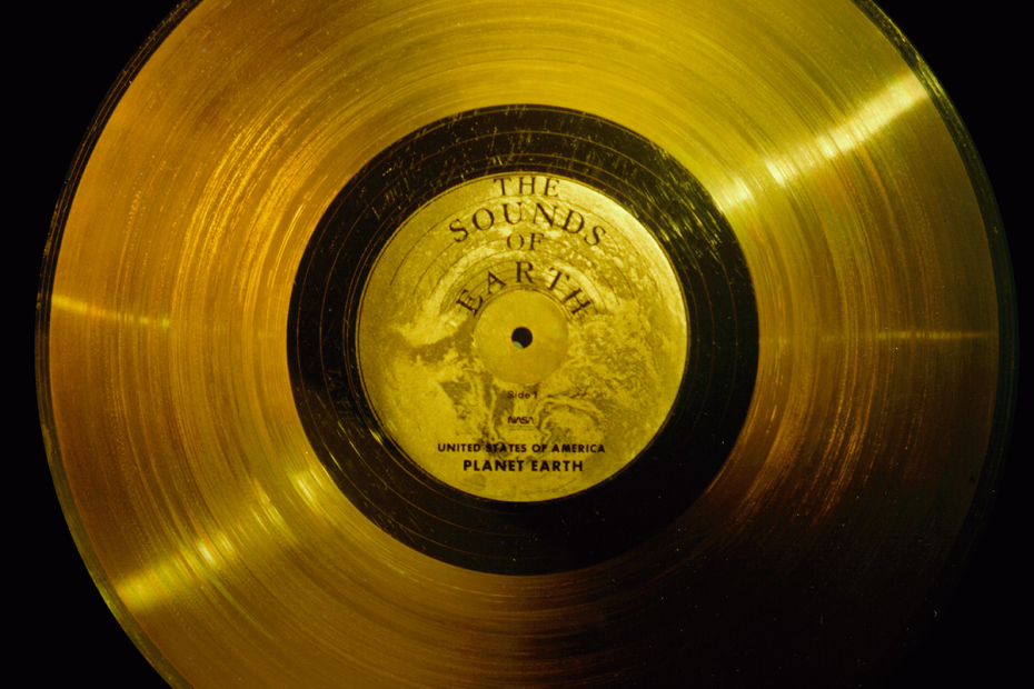 A gold record album with a label that reads "The Sounds of Earth" at top and "United States of America / Planet Earth" on the bottom.