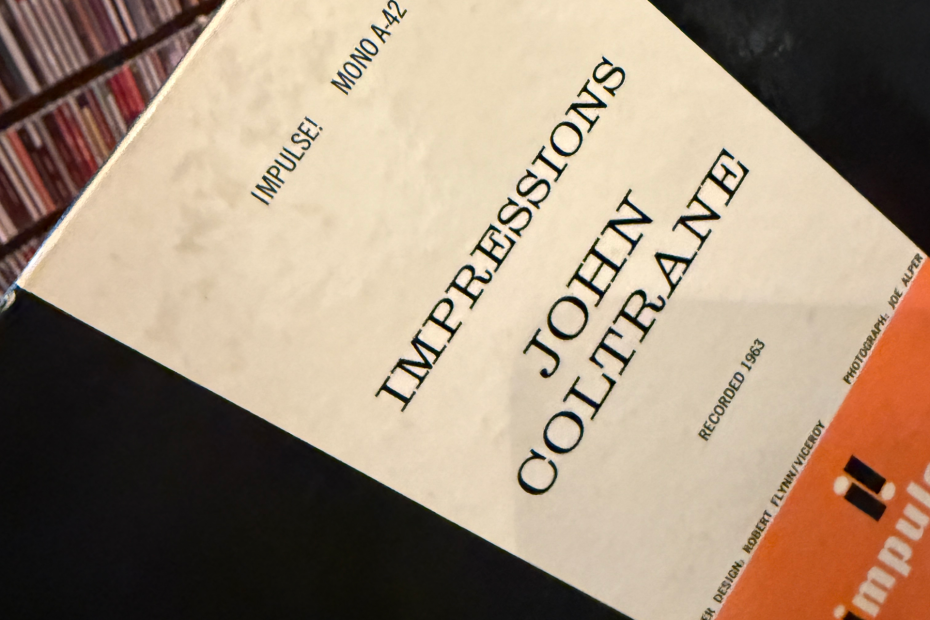 Close-up of the back of a vinyl album showing the title, artist, record label name, and recording year